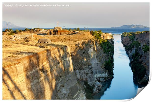 Coastal fortifications of the Corinth Canal in Greece in the bright rays of the morning rising sun. Print by Sergii Petruk
