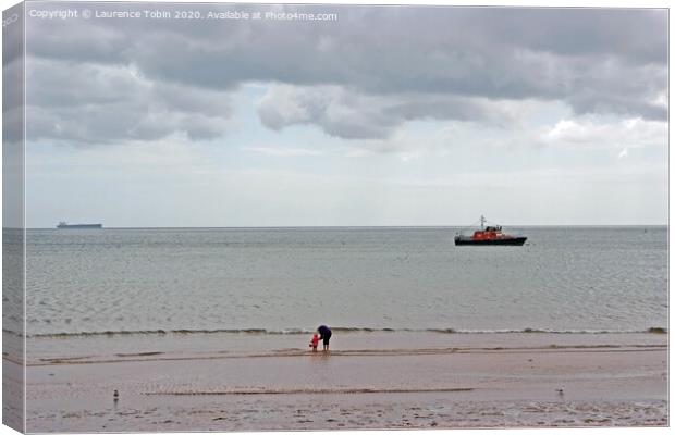 Paddling at low tide near Clacton, Essex Canvas Print by Laurence Tobin