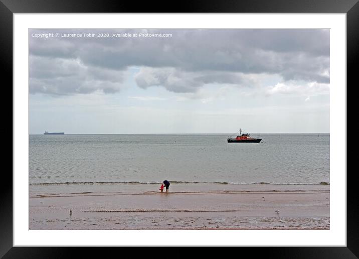 Paddling at low tide near Clacton, Essex Framed Mounted Print by Laurence Tobin