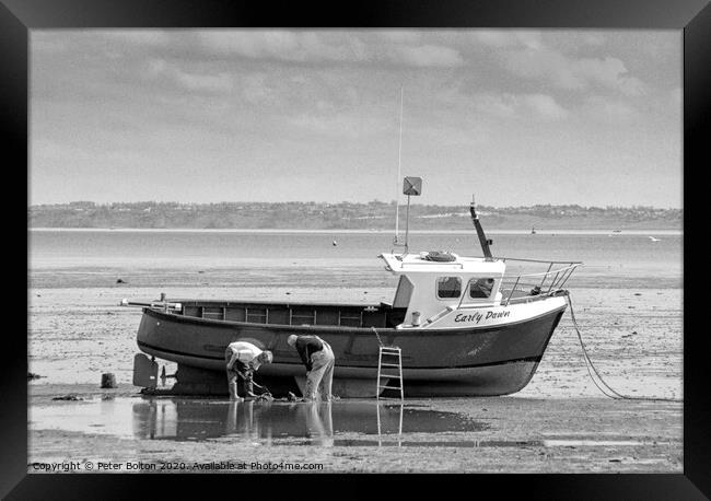 Fishermen maintain their boat at low tide at Thorpe Bay, Essex, UK. Framed Print by Peter Bolton