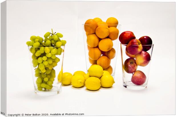 Still life of fresh fruits arranged as graphic design on a white background Canvas Print by Peter Bolton