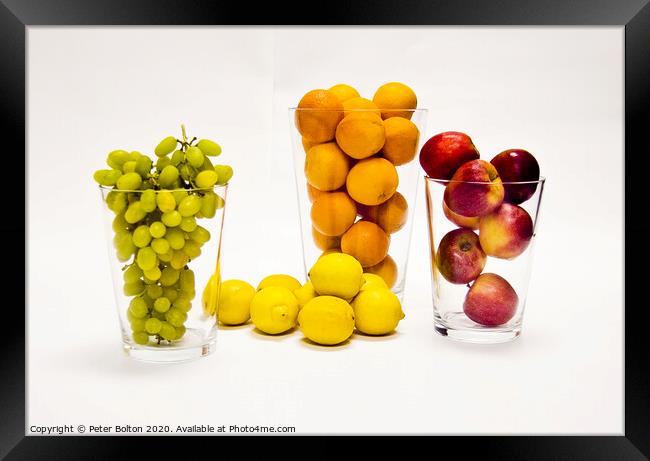 Still life of fresh fruits arranged as graphic design on a white background Framed Print by Peter Bolton
