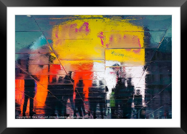Neon reflections in wet pavement at night Framed Mounted Print by Sara Melhuish