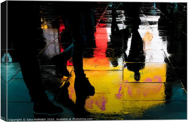 Feet and reflections in wet pavement Canvas Print by Sara Melhuish