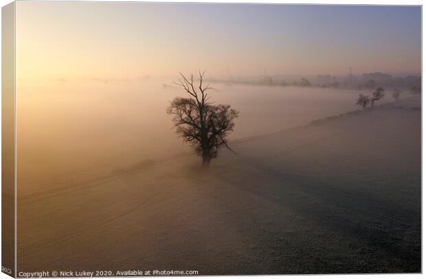 A sunrise over misty fields derbyshire Canvas Print by Nick Lukey