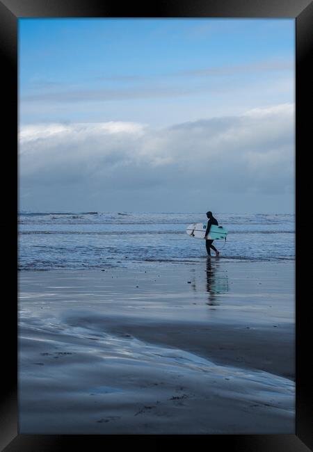 Surfer heading out to catch waves Framed Print by Tony Twyman
