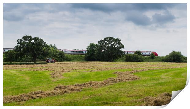 A Virgin train passes a tractor on a field Print by Jason Wells