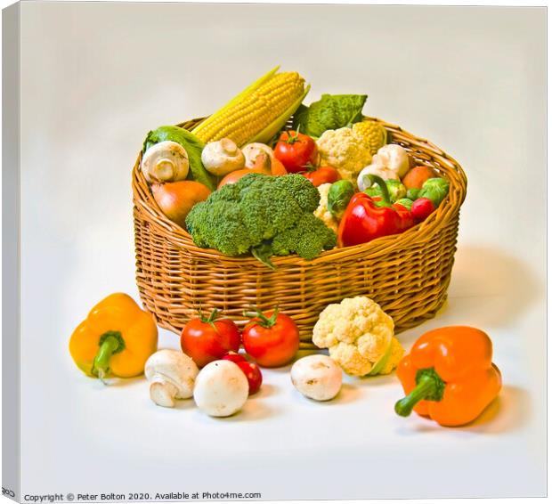 Studio still life of a basket of fresh vegetables on a white background. Canvas Print by Peter Bolton