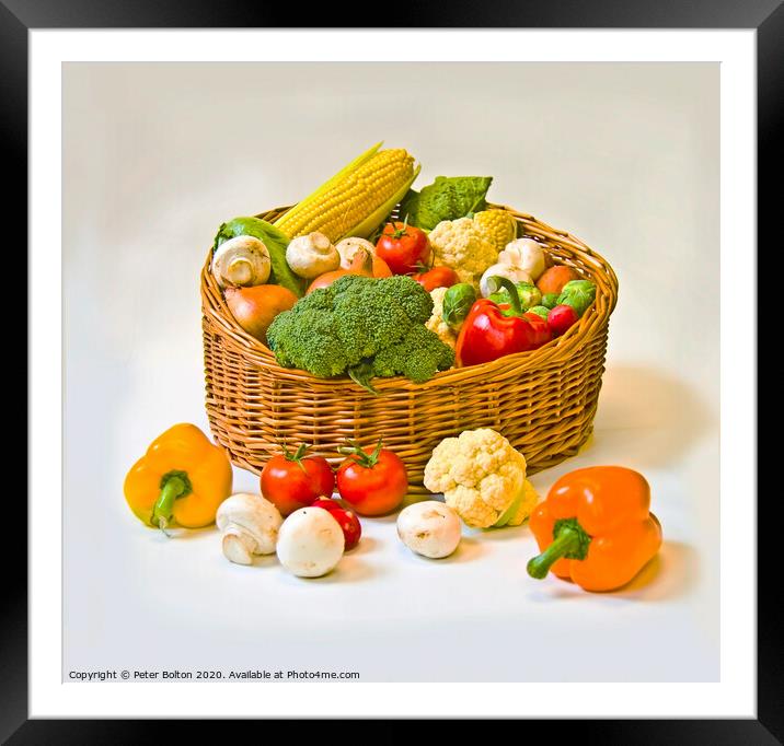 Studio still life of a basket of fresh vegetables on a white background. Framed Mounted Print by Peter Bolton
