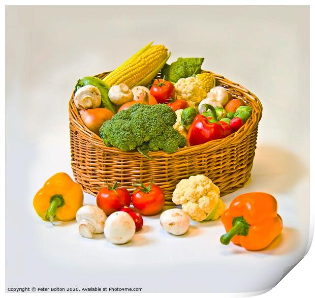 Studio still life of a basket of fresh vegetables on a white background. Print by Peter Bolton