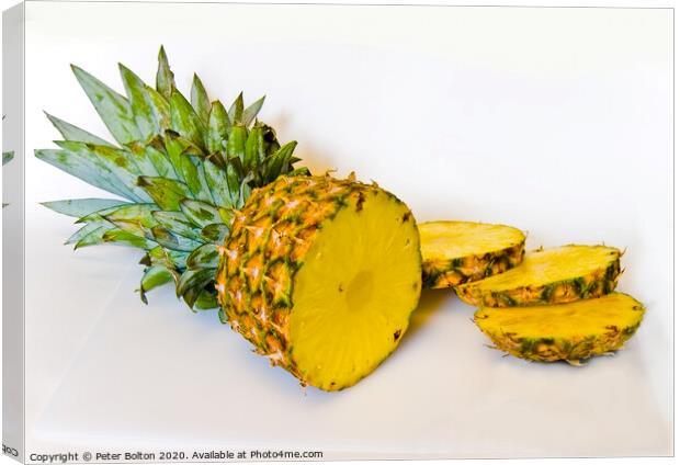 A studio still life close up of a pineapple sliced on a white background Canvas Print by Peter Bolton