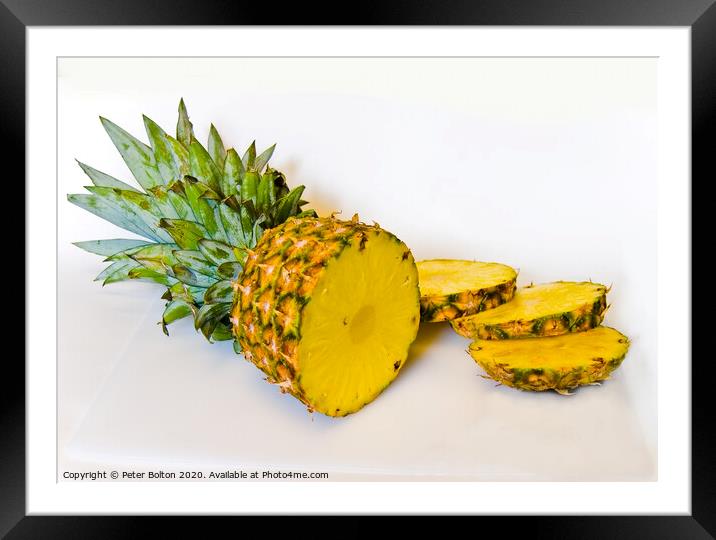 A studio still life close up of a pineapple sliced on a white background Framed Mounted Print by Peter Bolton