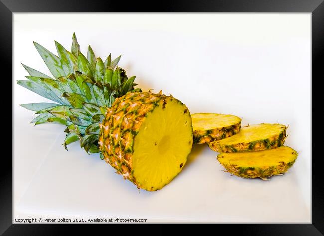 A studio still life close up of a pineapple sliced on a white background Framed Print by Peter Bolton