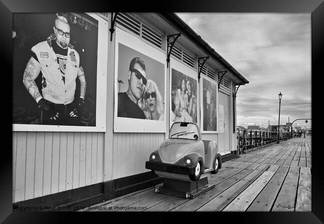 A shelter and children's coin operated ride on Southend pier, Essex, UK. Framed Print by Peter Bolton