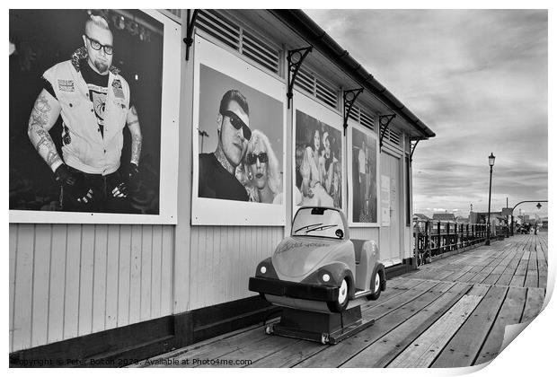 A shelter and children's coin operated ride on Southend pier, Essex, UK. Print by Peter Bolton