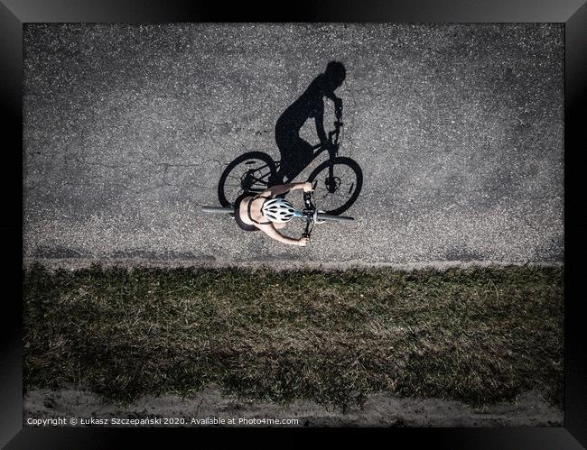 Cyclist on the road, top down image of shadow on t Framed Print by Łukasz Szczepański