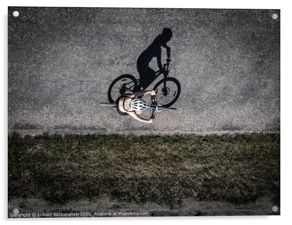 Cyclist on the road, top down image of shadow on t Acrylic by Łukasz Szczepański