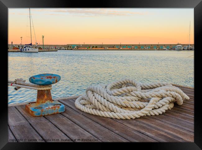 detail of a bollard with ropes for mooring at the  Framed Print by daniele mattioda