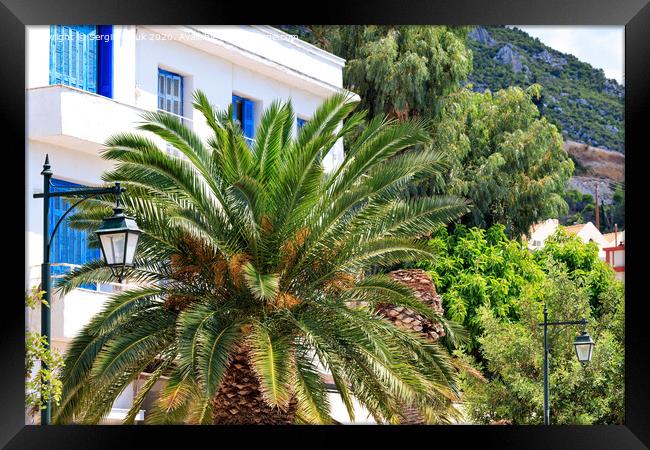 Beautiful landscape of a city street with growing date palm trees near a traditional white Greek house with blue wooden windows and doors. Framed Print by Sergii Petruk