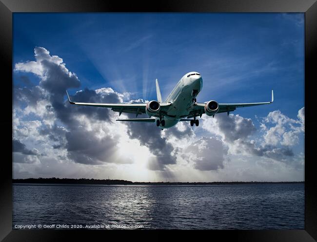 Jet Airliner Flying in subeams Framed Print by Geoff Childs
