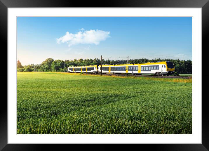 German passenger train in motion. Yellow electric train traveling Framed Mounted Print by Daniela Simona Temneanu