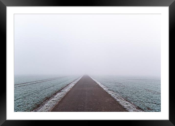 Pathway through frozen agricultural fields. Bicycle route in Germany on winter days Framed Mounted Print by Daniela Simona Temneanu