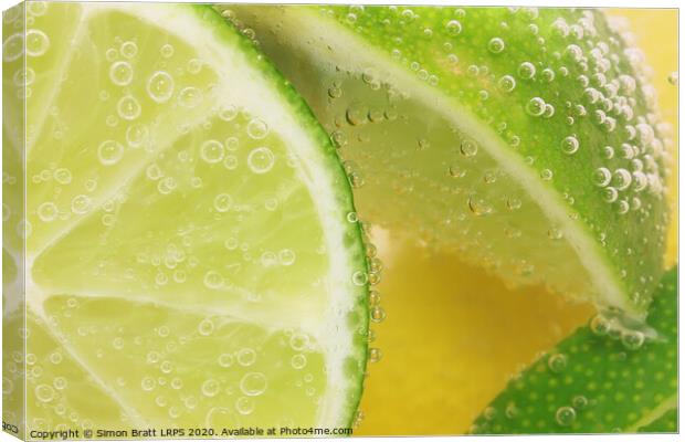 Lemon and lime slices in water Canvas Print by Simon Bratt LRPS