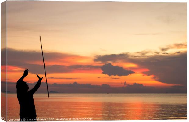 Man juggling at sunset in Thailand Canvas Print by Sara Melhuish