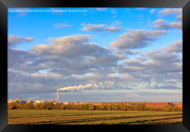 Rural autumn landscape, bright morning sunshine illuminate the agricultural field, the production complex on the horizon and a high cloudy sky. Framed Print by Sergii Petruk