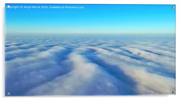 Aerial photos, cover of thick gray clouds in the bright sun in the blue sky above the horizon. Acrylic by Sergii Petruk
