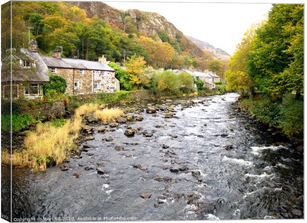 Tha river at Beddgelert village in Wales. Canvas Print by john hill