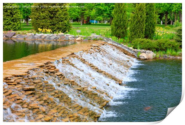 The waters of a beautiful decorative waterfall flow rapidly in a summer park. Print by Sergii Petruk