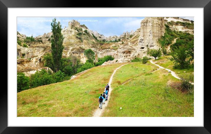 A group of tourists follow each other along a dirt path in Cappadocia, in central Turkey, a top view. Framed Mounted Print by Sergii Petruk