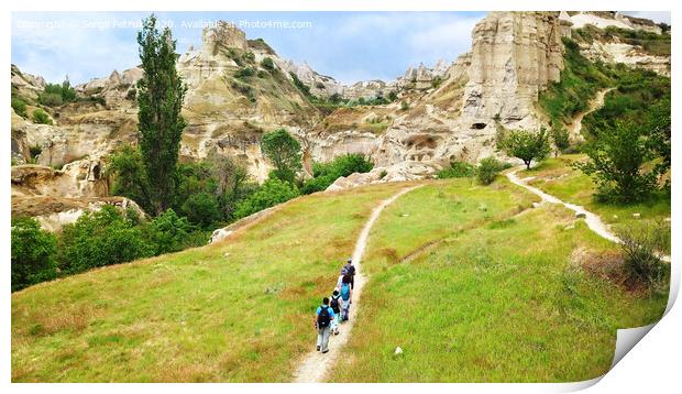 A group of tourists follow each other along a dirt path in Cappadocia, in central Turkey, a top view. Print by Sergii Petruk