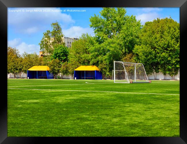 Green lawn of a soccer field with gates and tents for teams players. Framed Print by Sergii Petruk