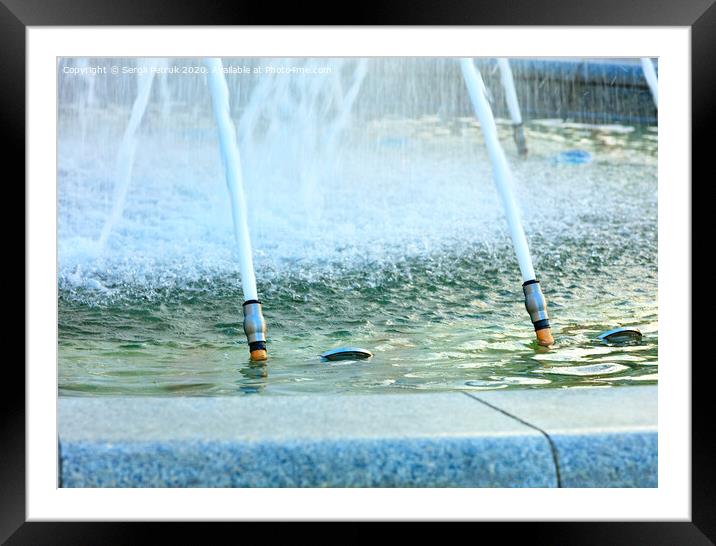 Powerful jets of water in a city fountain made of polished granite burst from metal nozzles. Framed Mounted Print by Sergii Petruk