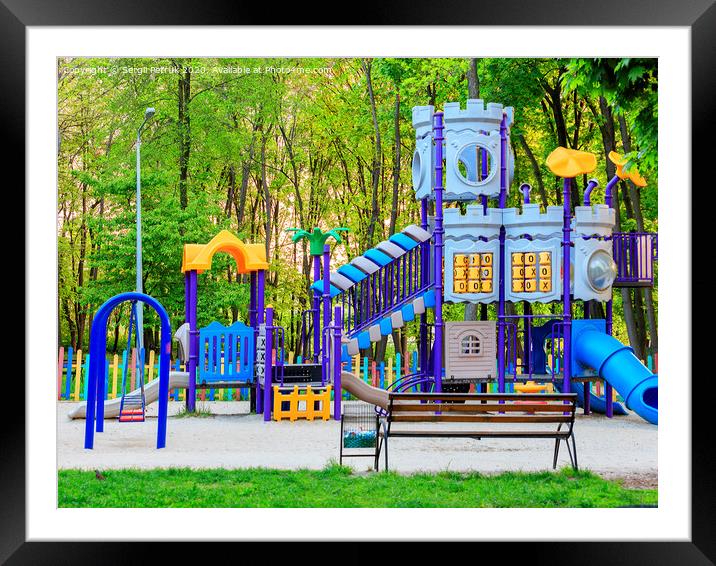 Bright children's colorful playground in the city summer park. Framed Mounted Print by Sergii Petruk