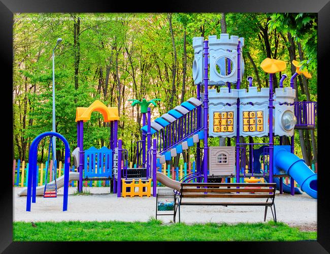 Bright children's colorful playground in the city summer park. Framed Print by Sergii Petruk