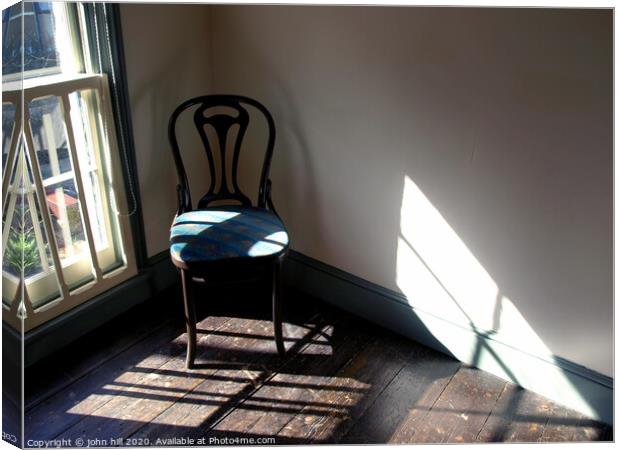 Chair in a empty room. Canvas Print by john hill