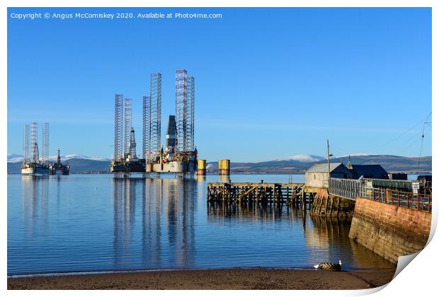 Decommissioned oil rigs off Cromarty harbour Print by Angus McComiskey