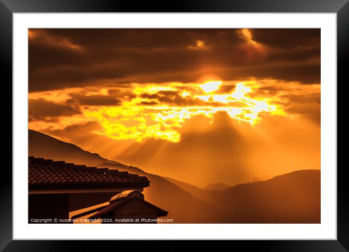 a golden sunset of threatening clouds  Framed Mounted Print by susanna mattioda