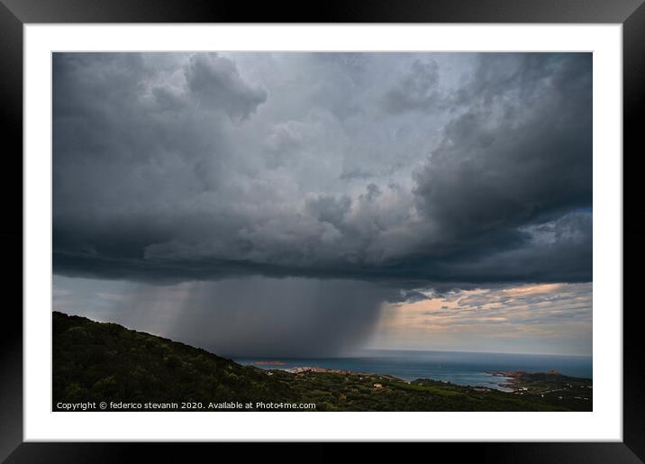 Dark large stormy clouds over hills and sea Framed Mounted Print by federico stevanin