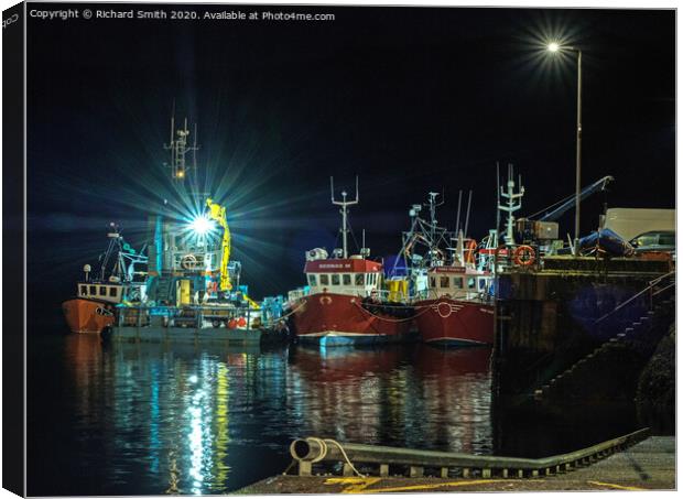 Workboat and Trawlers moored to Portree pier at night. Canvas Print by Richard Smith