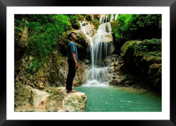 Young man enjoys the waterfall Mudal Framed Mounted Print by Hanif Setiawan