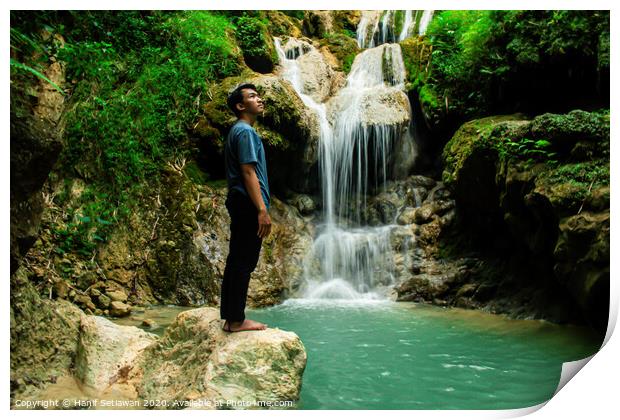 Young man enjoys the waterfall Mudal Print by Hanif Setiawan