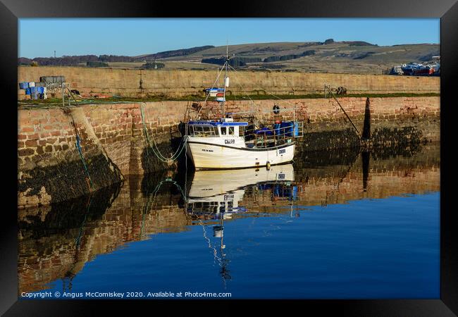 Fishing boat tied up in Cromarty harbour Framed Print by Angus McComiskey