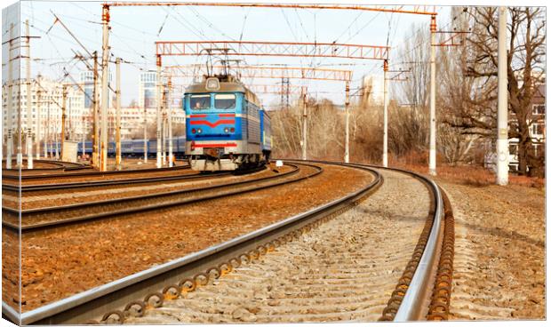 Multichannel railway tracks with a turn for the passage of electric trains. Canvas Print by Sergii Petruk