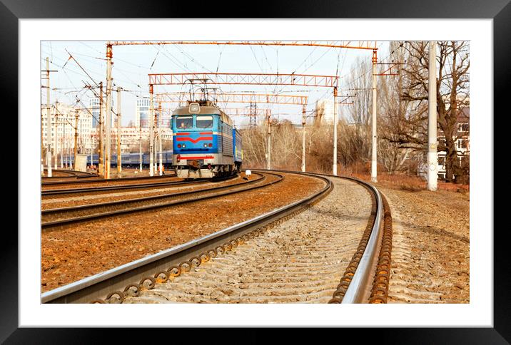 Multichannel railway tracks with a turn for the passage of electric trains. Framed Mounted Print by Sergii Petruk