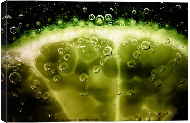 Lime slice in fizzy water Canvas Print by Simon Bratt LRPS
