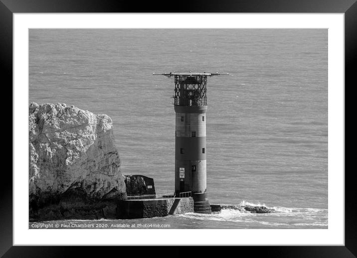 The Needles Lighthouse is an active 19th century lighthouse on the outermost of the chalk rocks at The Needles on the Isle of Wight in the United Kingdom Framed Mounted Print by Paul Chambers